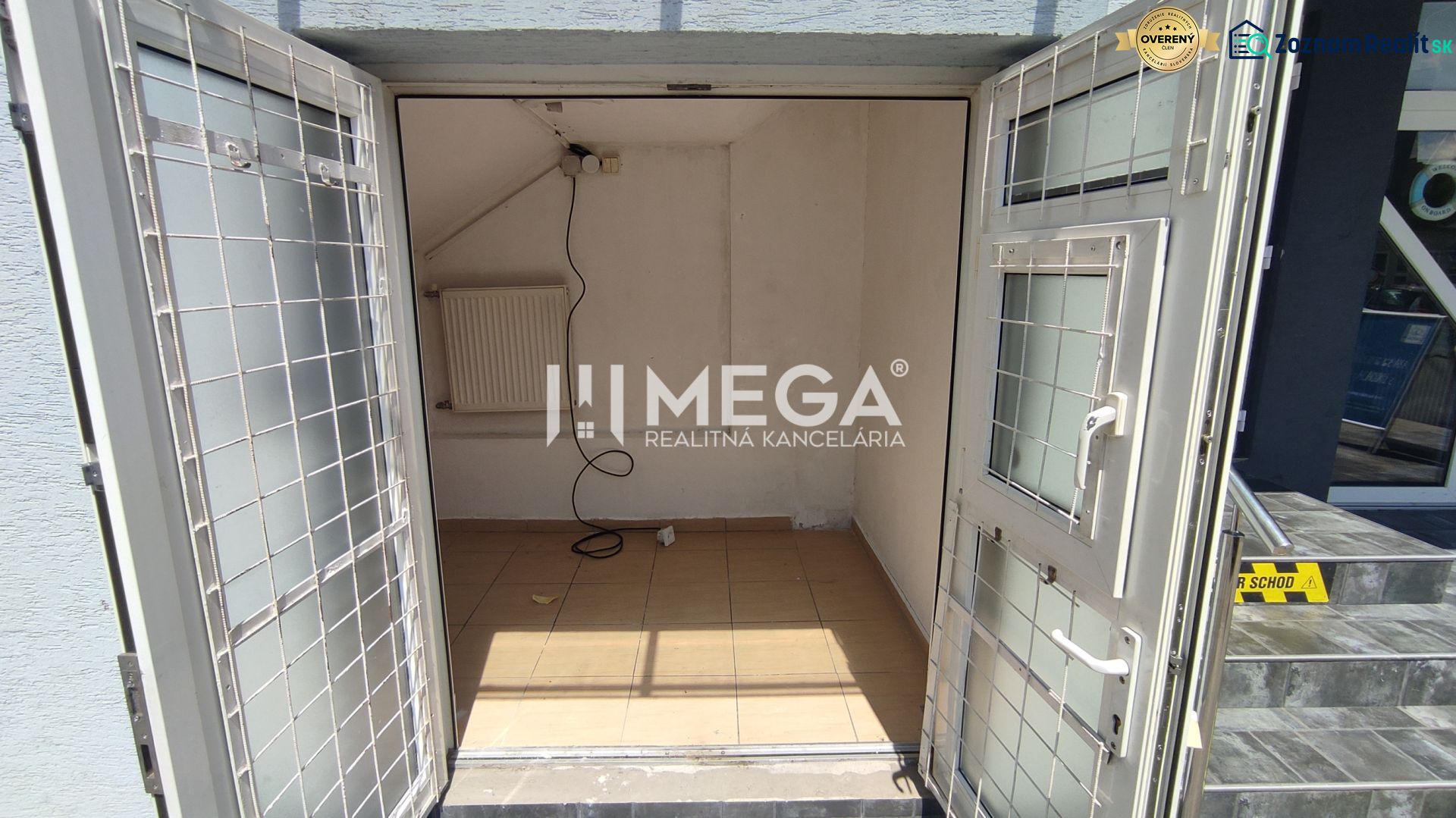 Commercial premises with open doors, tiles, and a radiator.