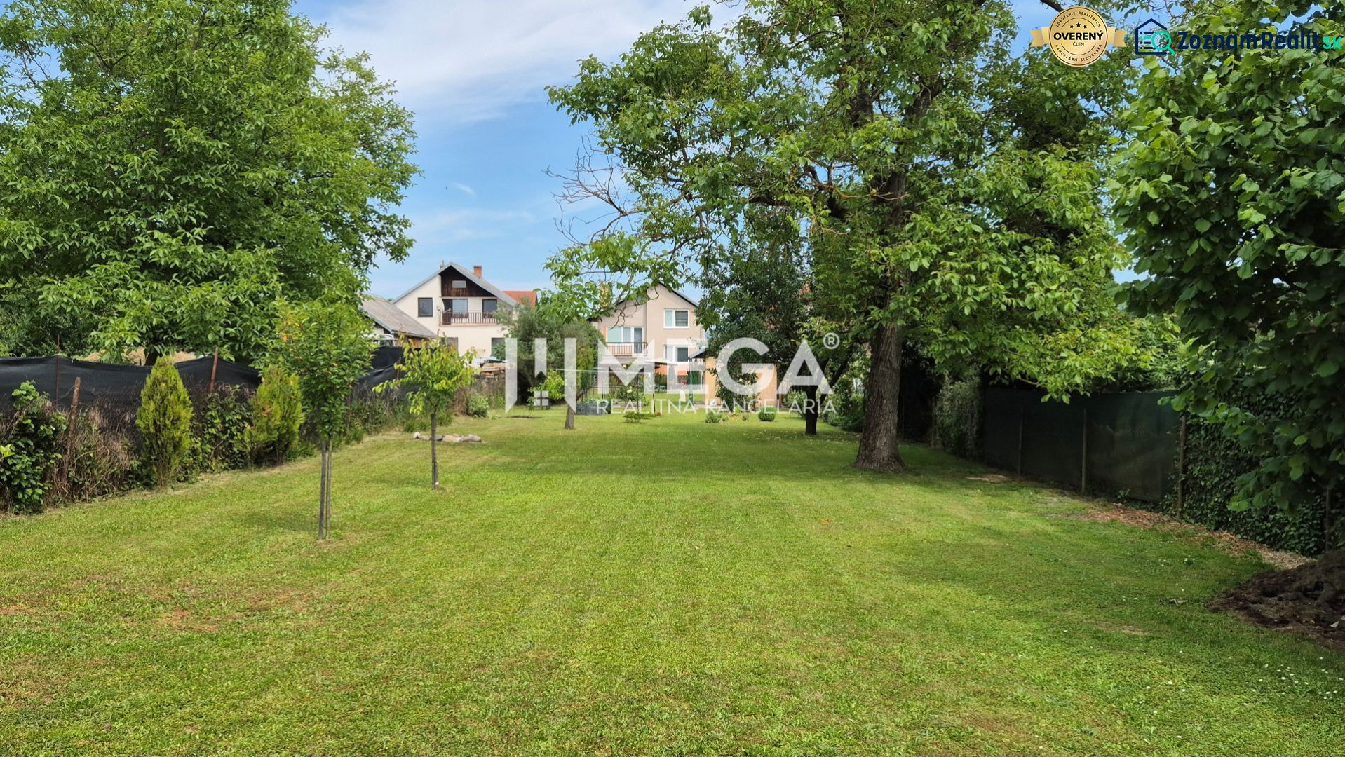 A garden at a family house in Lackovce with a well-maintained lawn and trees.