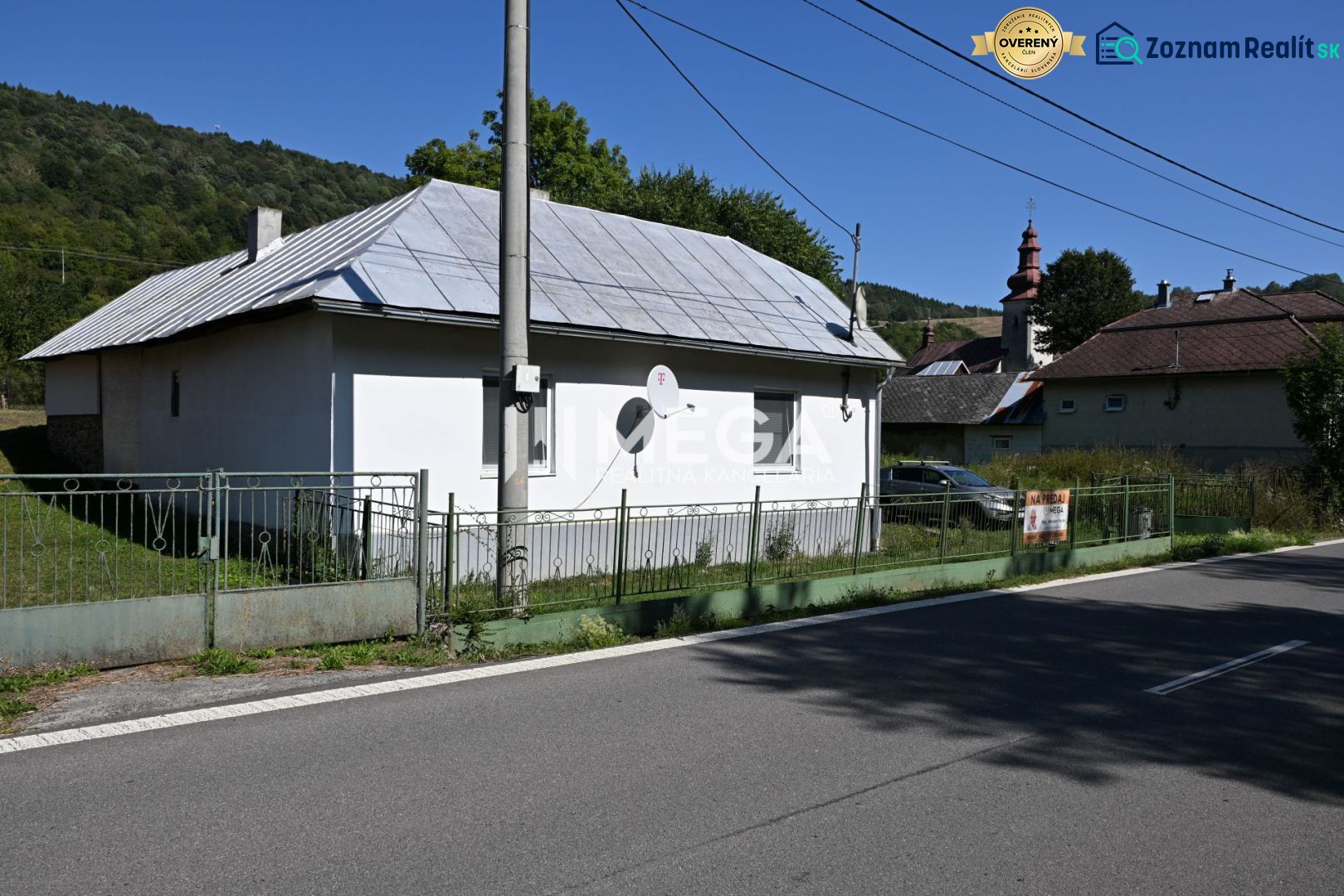 A family house in Kolbasov on Kolbasov Street, with a metal roof and fencing.