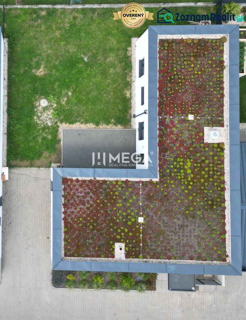 A family house on Gaštanová Street in Humenné with a green roof and an adjacent yard.