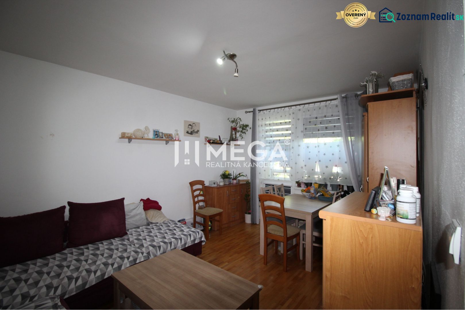 Living room in a two-room apartment with a sofa and a dining table.