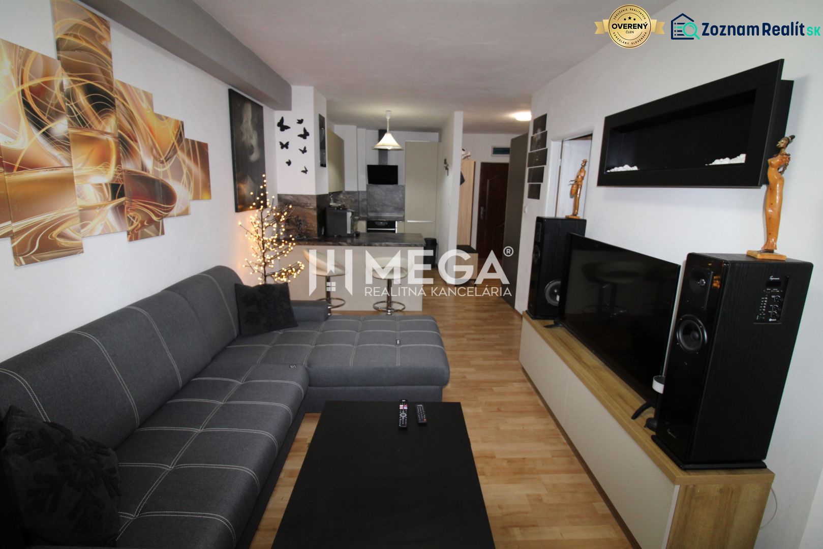 Living room in a 2-room apartment with a corner sofa and a floor with a wooden decor.