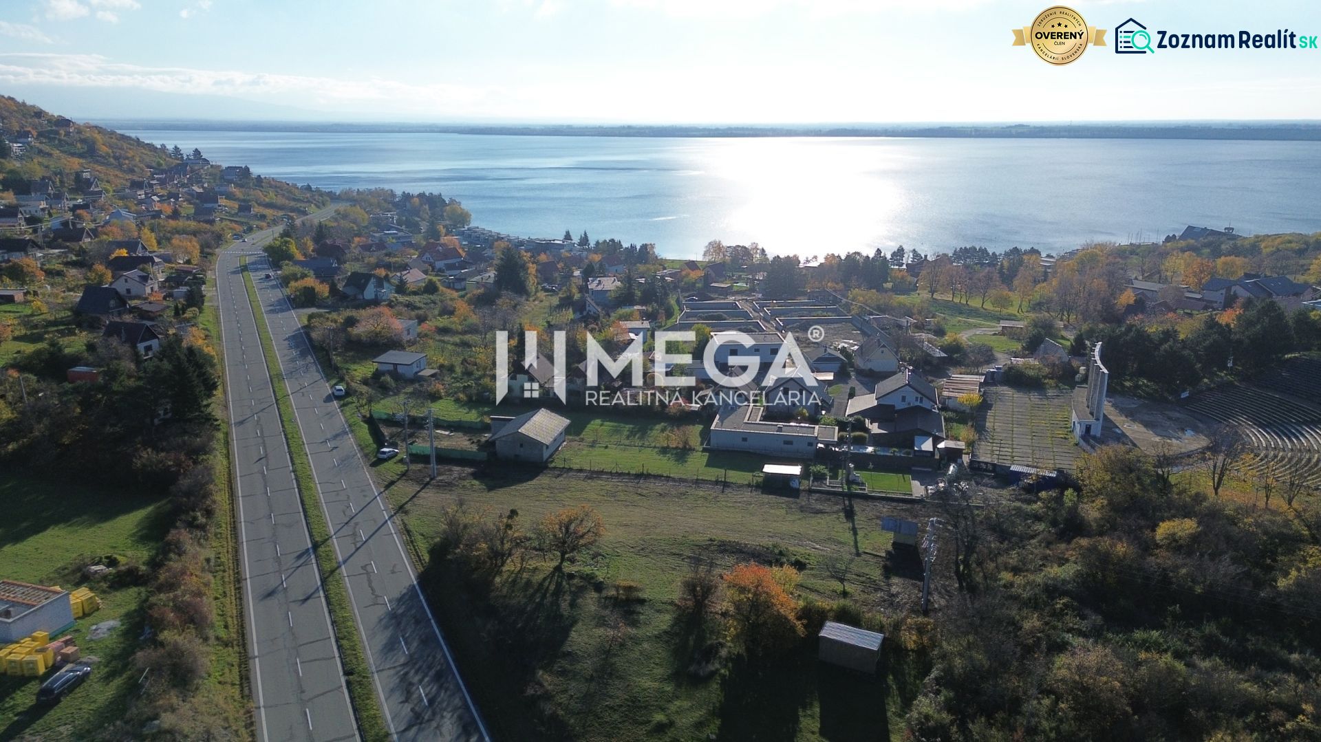 Aerial view of properties in the village of Vinné near the lake in the autumn season.