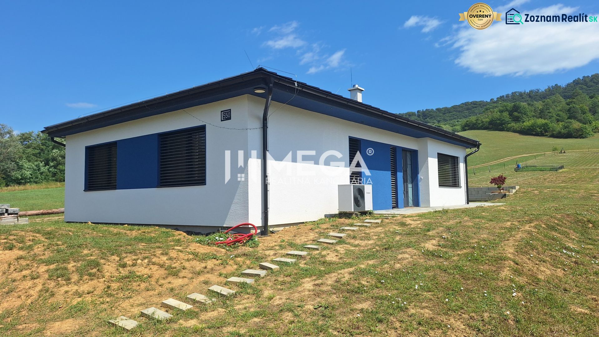 A family house in Jasenov on Jasenov Street surrounded by natural landscape and blue shutters.