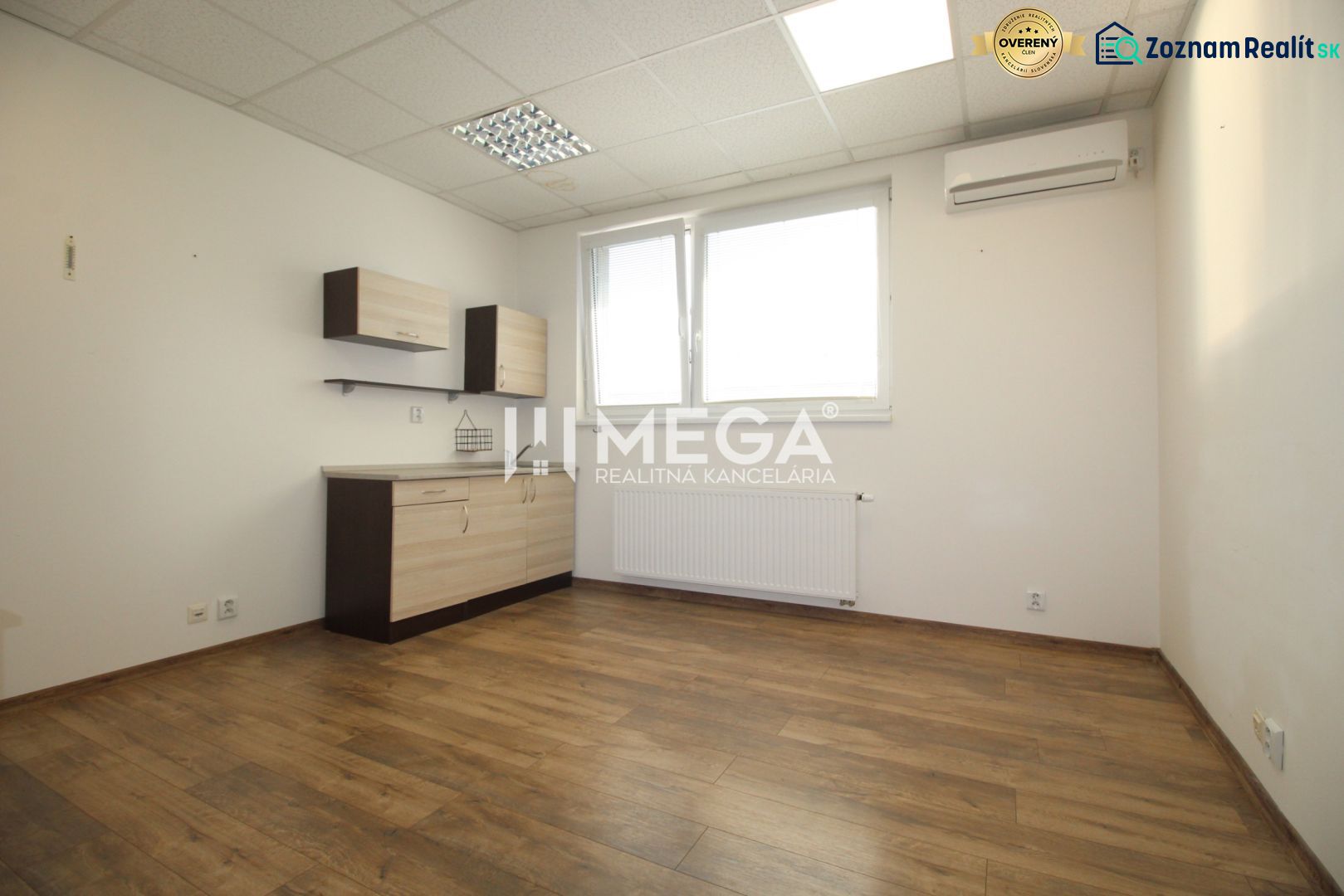 An office with white walls, wooden floor decor, and storage space.