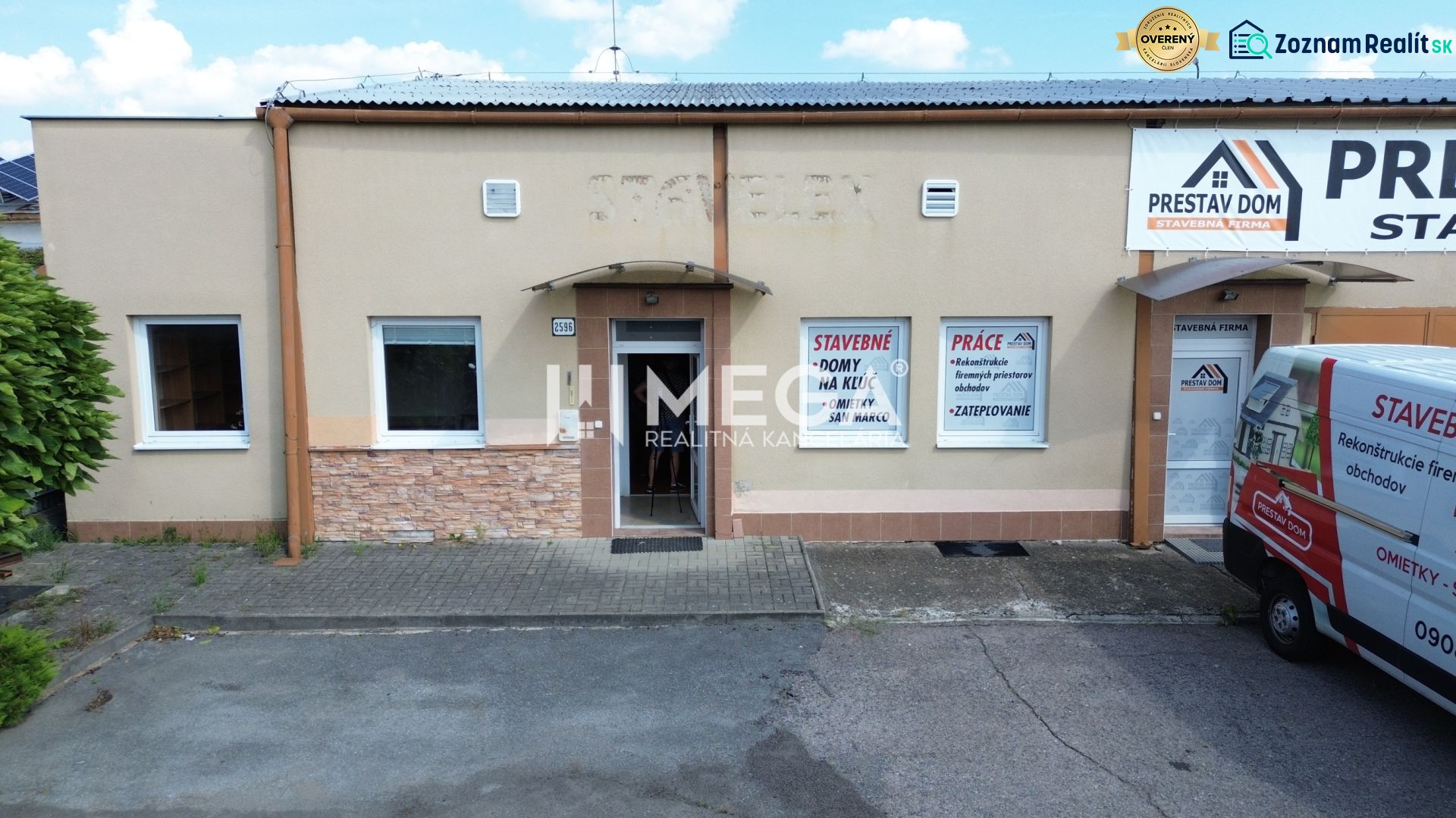 The building of a construction company on Fidlikova Street in Humenné with a parking lot and advertising space.