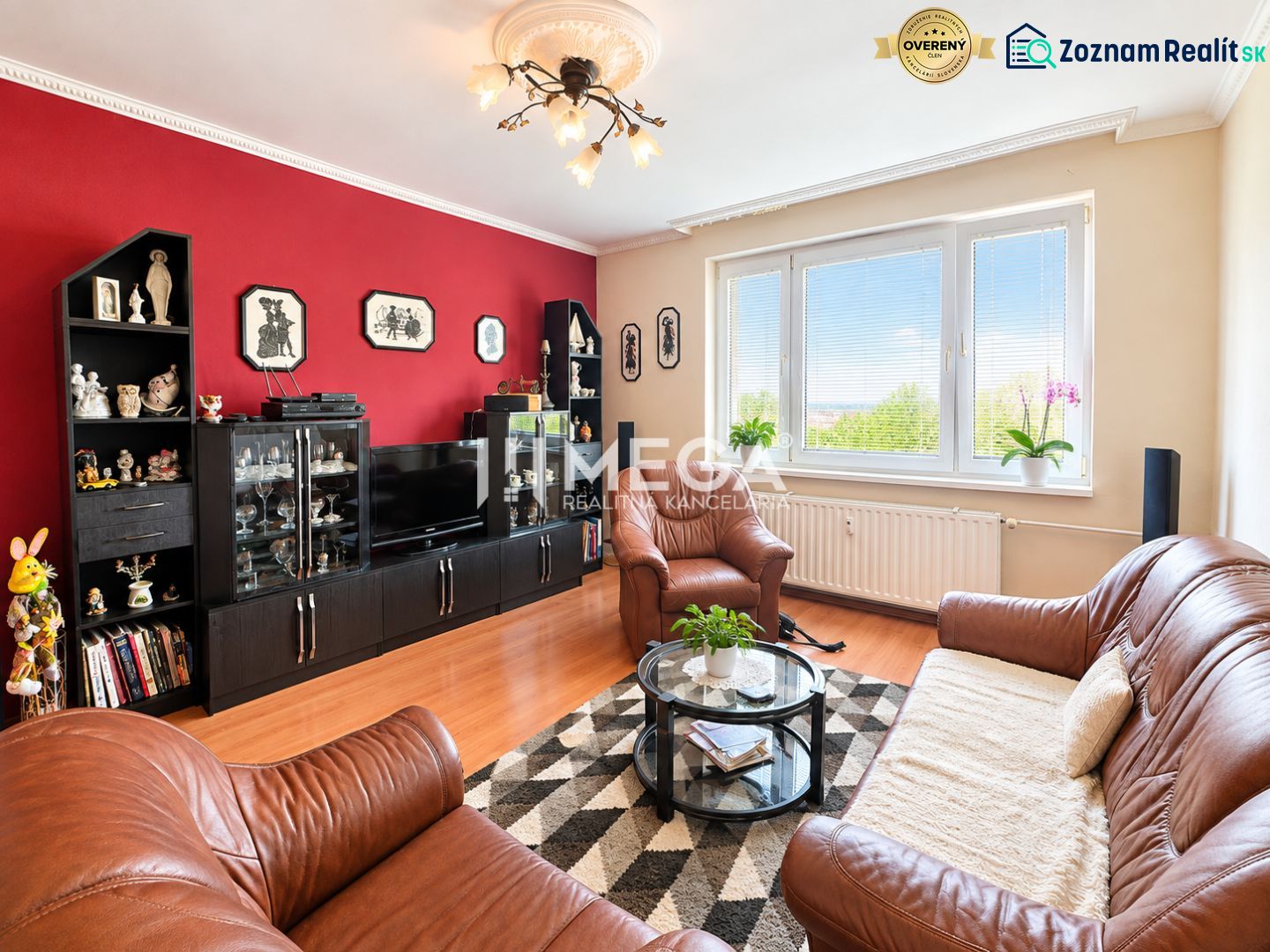 Living room with a sofa, glass table, and wooden decor flooring in a 4-room apartment.