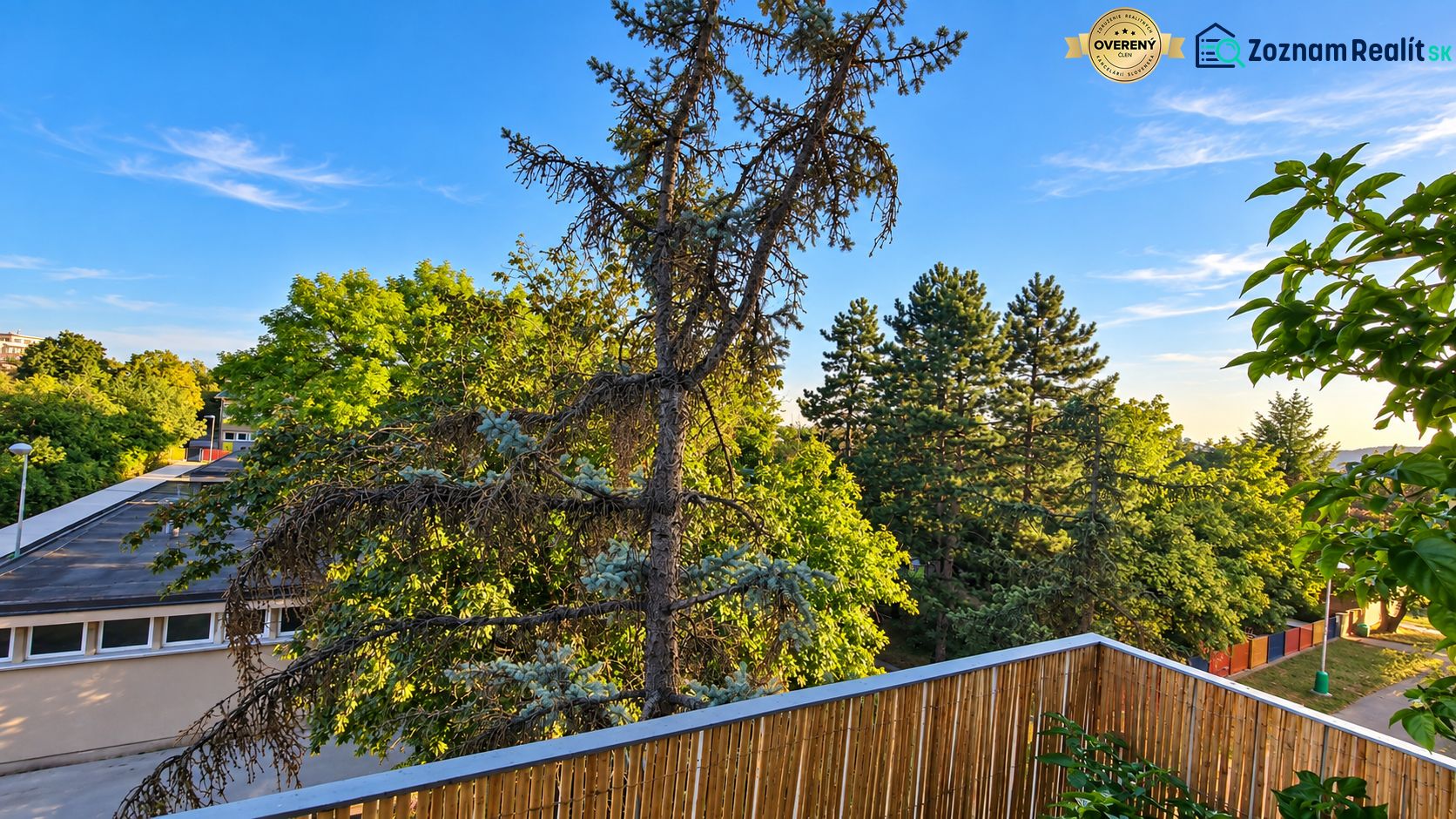 View from a 3-room apartment on Za hradbami Street in Pezinok surrounded by greenery.