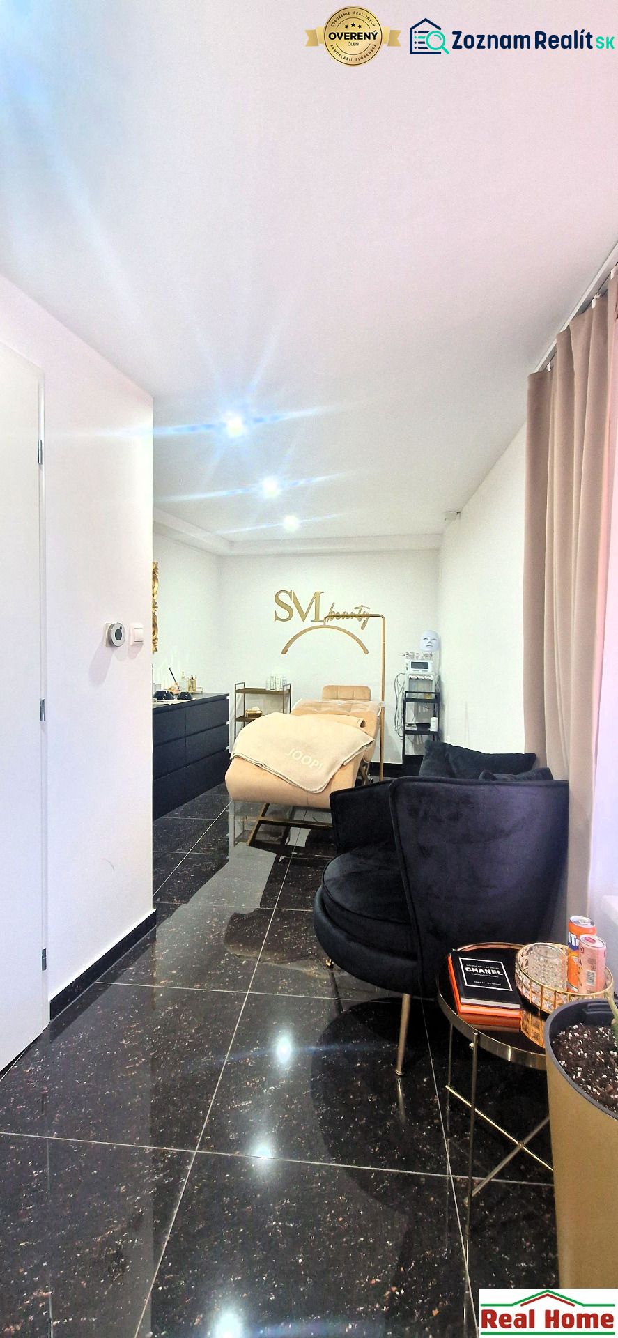 Interior commercial spaces with a sofa set, mirror, and gold accessories.
