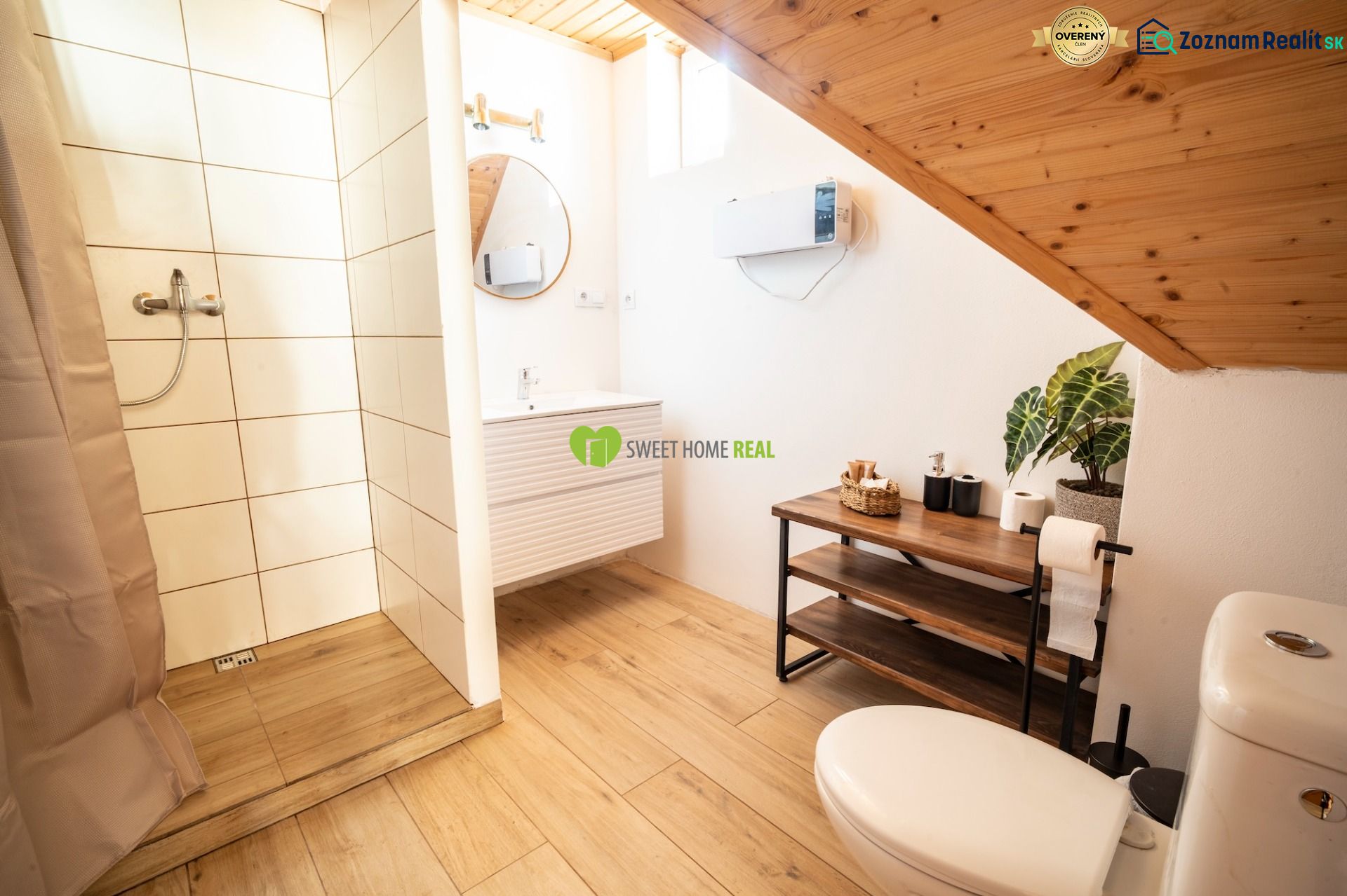 Bathroom with wood-patterned flooring, shower, and sink. Hotels and guesthouses.