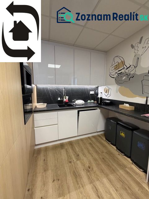 A kitchen in a building with a wooden decor floor and modern furniture.