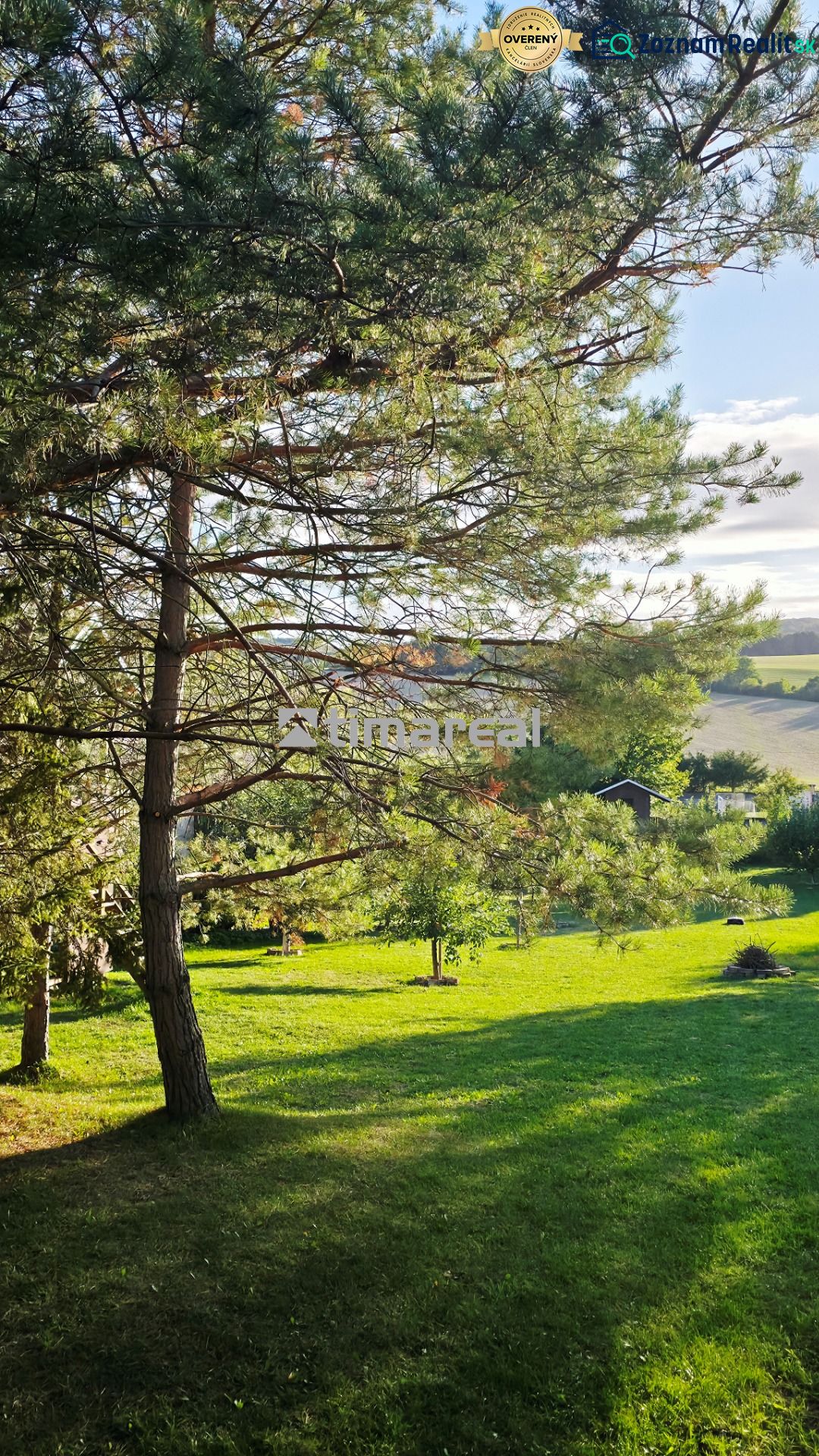 Garden in Dobrá Voda near a family house with a lawn and trees.
