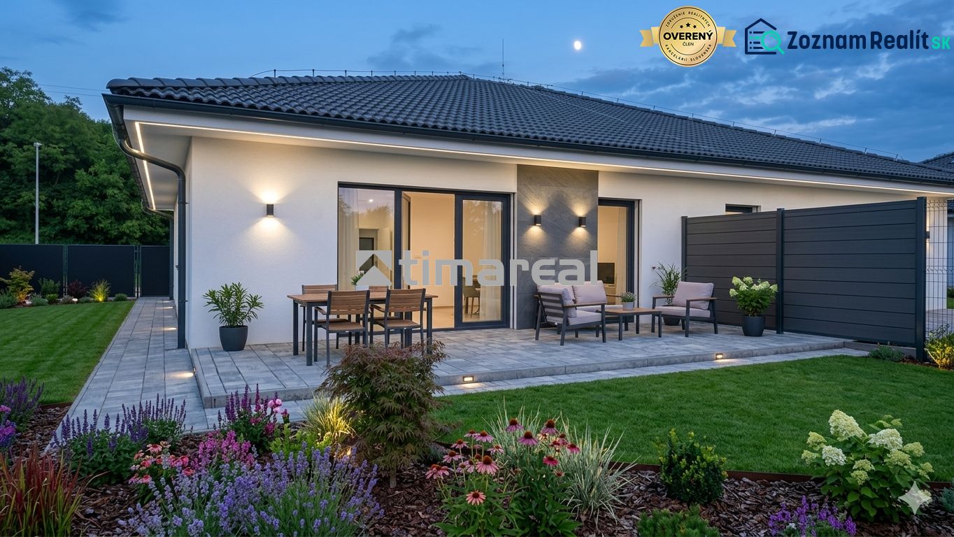 A family house in Hôrka nad Váhom with a terrace, lighting, and a garden during the evening.