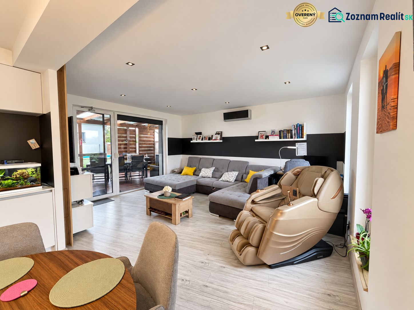 Living room with a massage chair and wooden decor flooring in a family house.