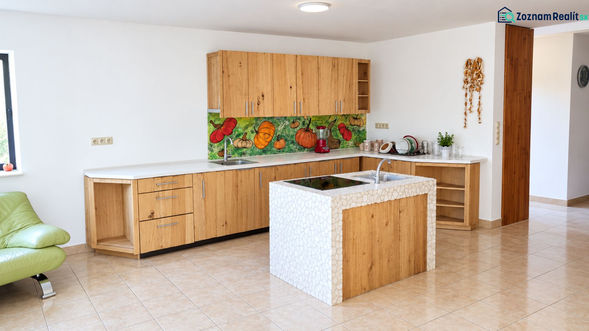 A kitchen in a family house with a kitchen unit and a colorful vegetable backsplash.