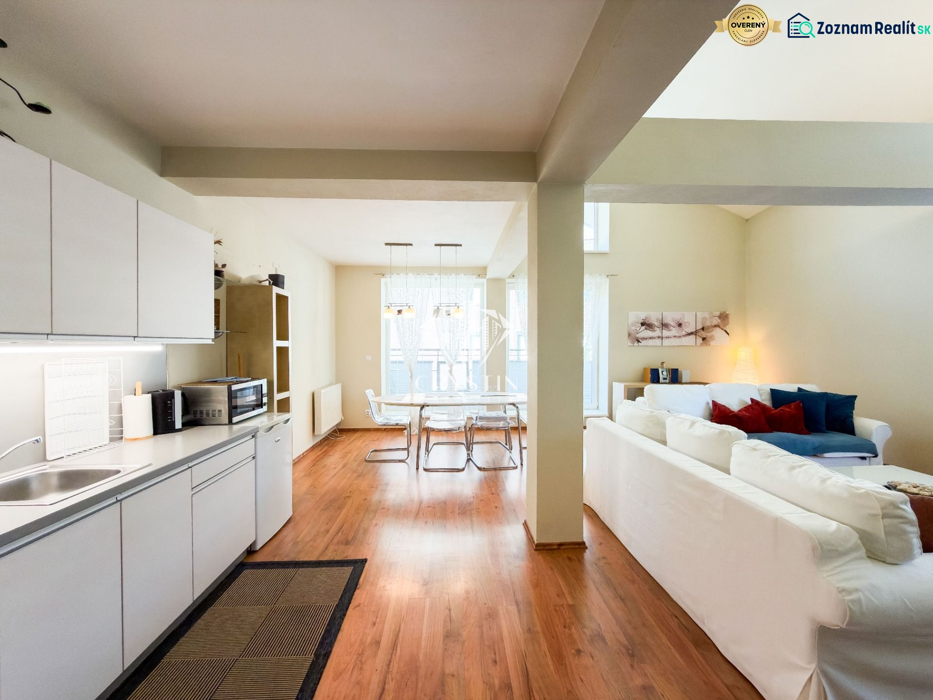 Kitchen and living room with wood-patterned flooring in a 3-room apartment.