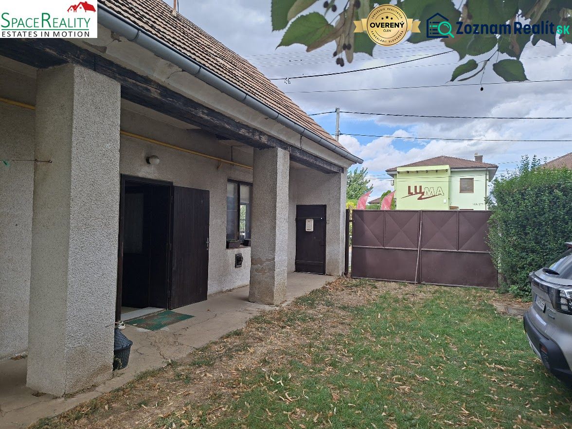 An older building with a garden on Main Street in Viničné, suitable for residential land.