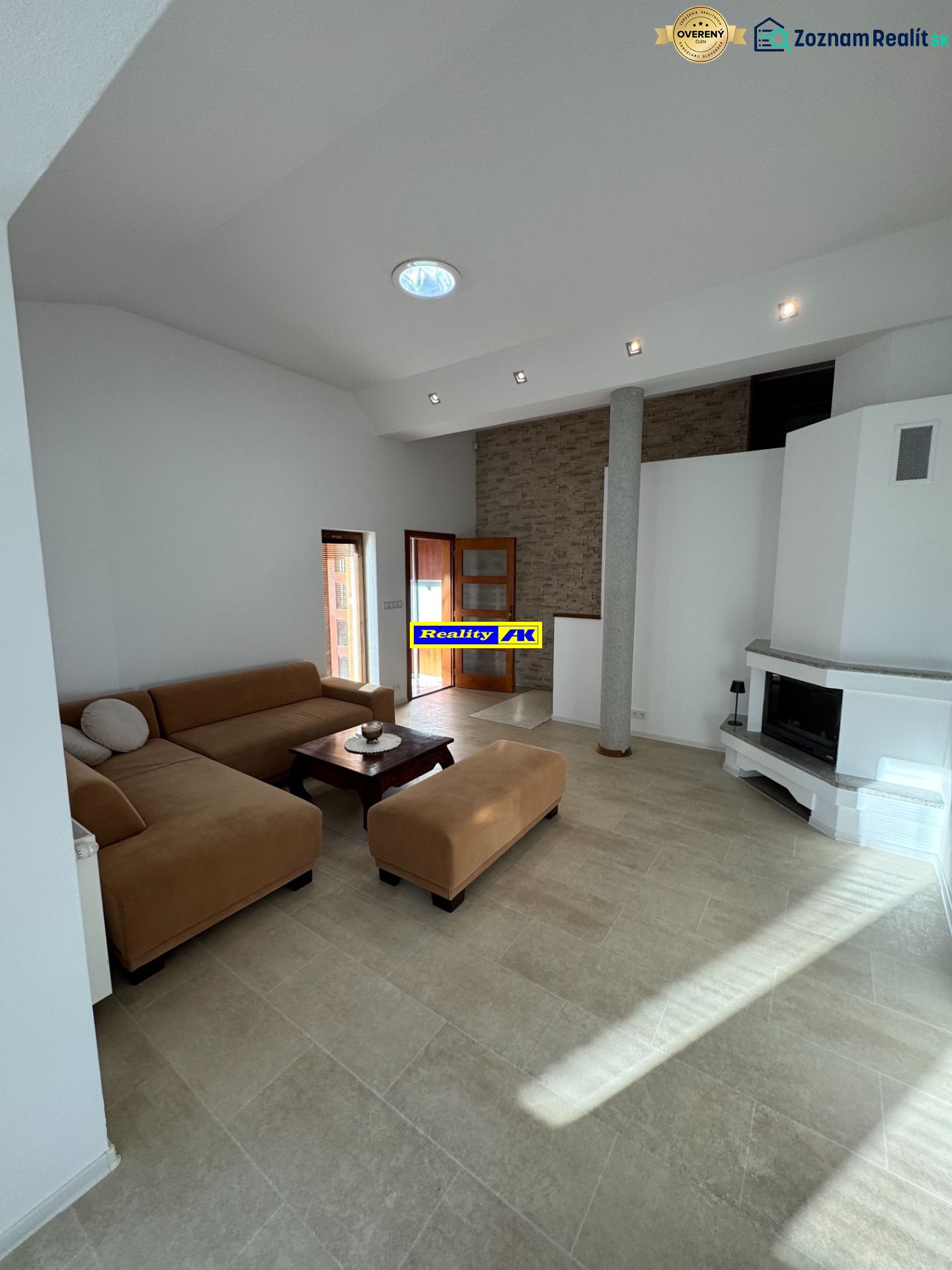 Living room in a family house with a fireplace and a spacious sofa set.