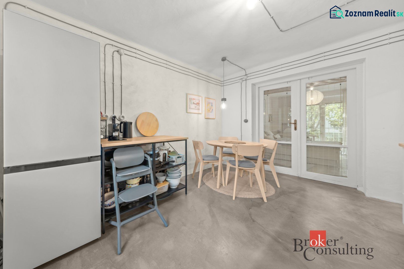 Dining room with a round table and glass doors in a two-room apartment.
