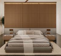 A bedroom in a minimalist style with a large bed and wooden elements. House construction.