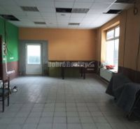 Spacious commercial spaces with windows and doors, tiled floor.