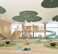 Children's playroom with a wooden decor floor, slide, and creative ceiling. Apartment construction.