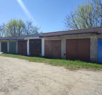 A row of garages on Veterná in Holíč, surrounded by trees and grassy surfaces.
