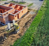 Construction of a family house in Trenčín with a brick wall and building equipment.