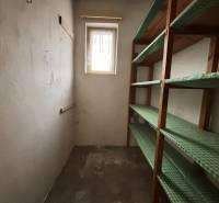 A small room with a bright window and wooden shelves in a 4-room apartment.