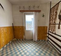 Interior of a 4-room apartment with ceramic flooring, wooden paneling, and hunting trophies.