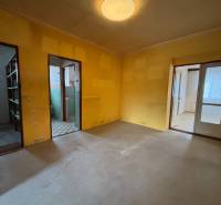 A room in a 4-room apartment with colorful walls, tiles, shelves, doors with panels.
