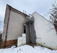 The snow-covered back of the building in Zamarovce, on the outskirts of Trenčín.