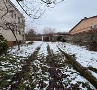 The garden at the 4-room apartment in Zamarovce, Trenčín, covered with snow and fallen leaves.