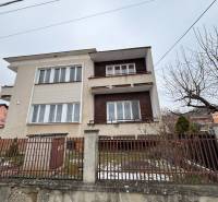 A two-story house in the Zamarovce district of Trenčín, with a metal fence and a garden.