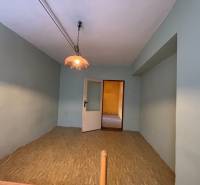 A room in a 4-room apartment with a bright chandelier and open doors.