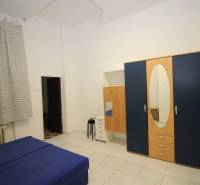 1-bedroom apartment with blue furniture, a wardrobe, and curtains.