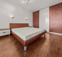 Bedroom in a 2-room apartment with a bed, nightstands, and a wardrobe.