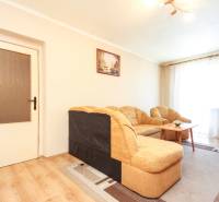 Living room with a sofa and a table in a three-room apartment.