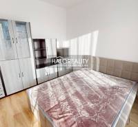 A bright bedroom with a large bed and wardrobes in a 2-room apartment.