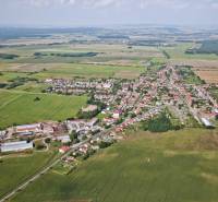 Aerial view of the village Borský Svätý Jur with surrounding fields and buildings.