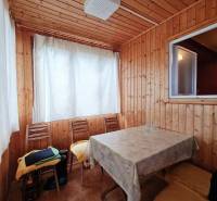 Interior with wood paneling, table and chairs, Home construction.