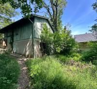 Cottage on Harmony in Modra with surrounding greenery and adjacent building.