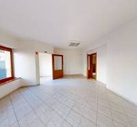 A bright room with tiles and a wooden window in a family house.
