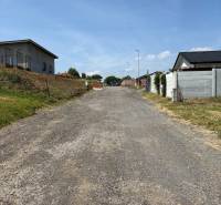 A gravel road leads to the houses in Gregorovce, ideal for residential plots.