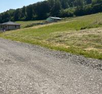 Plots - living in Gregorovce with a grassy slope, forest, and two houses in the countryside.