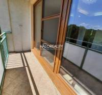 Balcony of a 4-room apartment with wooden window frames and glazing, view of the surroundings.