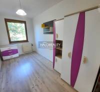 Children's room in a 4-room apartment with colorful furniture and wooden flooring.