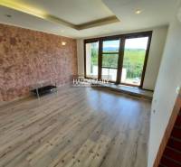 Living room in a 4-room apartment with large windows and wooden flooring.