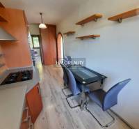 A kitchen with tables and shelves in a 4-room apartment, wooden cabinets.