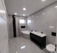 The bathroom on Ady Street in the family house has a bathtub, toilet, sink, and shower.